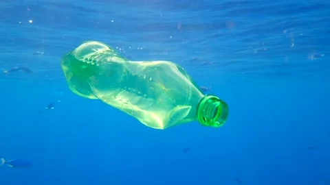 Plastic pollution, Discarded green plastic bottle slowly drifting under surface Stock Footage 149980095