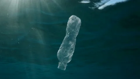 Plastic pollution, discarded plastic bottle slowly drifts under surface of water Stock Footage 170608618