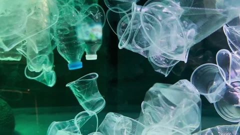 Plastic pollution, discarded plastic cups slowly drifting under surface of the Stock-Footage 261695018