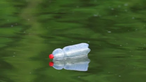 Plastic Pollution Floating Down a summer River in Slow Motion Stock Footage 340605255