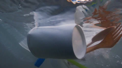Plastic pollution floating on sea waves Stock Footage 317605339