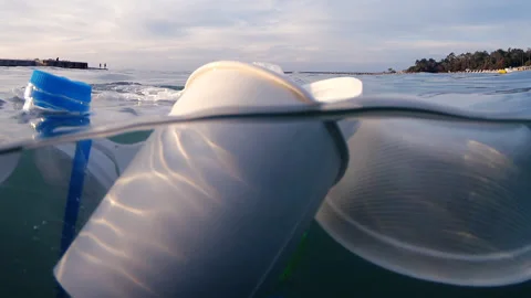 Plastic pollution floating on sea waves Stock Footage 317605448