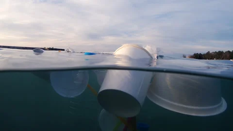 Plastic pollution floating on sea waves Stock Footage 317605538