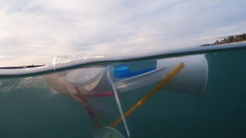 Plastic pollution floating on sea waves Stock Footage 317605660