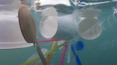 Plastic pollution floating on sea waves Stock Footage 317605964
