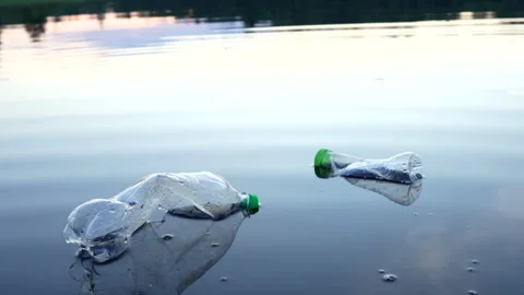 Plastic pollution in lake. Ocean waste pollution, marine debris. Stock Footage 286136221