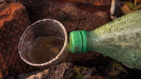 Plastic pollution of nature. Plastic bottle and glass on the grass. Stock Footage 126000655