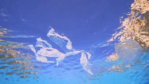 Plastic pollution in ocean environmental problem. Plastic bags, cups, straws and Stock Footage 101714186