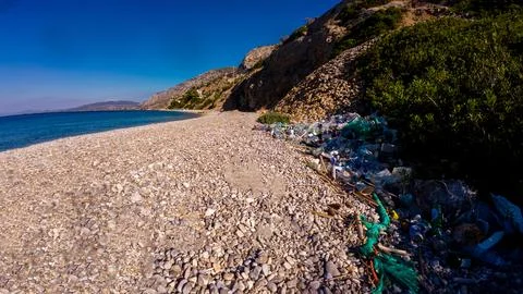 Plastic Pollution On Pebble Beach Stock Photos