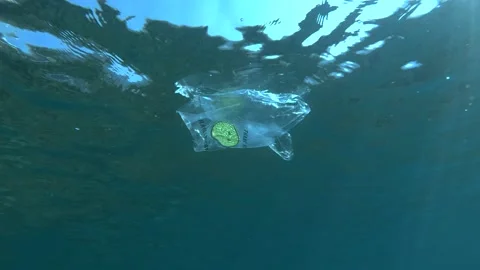 Plastic pollution, plastic bag with a yellow smiley face and inscription on bag Stock Footage 143649051