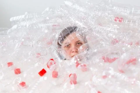 Plastic pollution problem and environment protection. Weak tired woman in a pile Stock Photos
