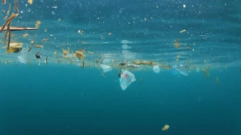 Plastic pollution problem. Bottles and bags dumped in sea causing environmental  스톡 동영상 65449729