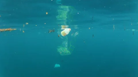 Plastic pollution problem. Bottles and bags dumped in sea causing environmental  스톡 동영상 65449766