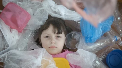 Plastic pollution problem. A child in plastic trash. Stock Footage 127060491