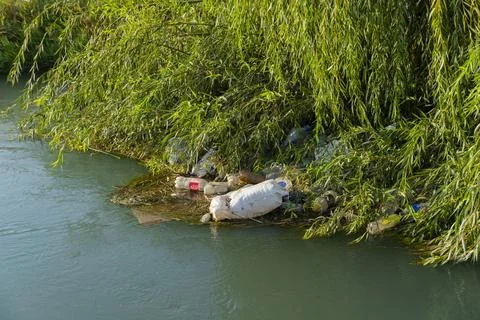 Plastic pollution in river water Stock Photos