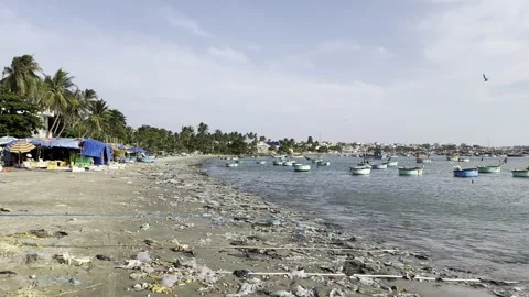 Plastic pollution scattered on sandy ocean beach Stock Footage 340806229