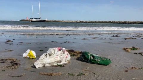 Plastic pollution two masted yacht in background 動画素材 139913619