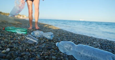 Plastic pollution. A volunteer cleans the beach by the ocean. Safe ecology Stock Footage 115917916