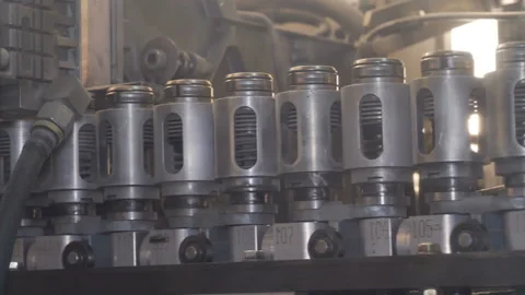 Plastic preform bottles move through the machine for blowing Stock Footage 98721902