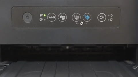 The plastic printer's power button has been pressed and the power light is blue. Stock Footage 320889415