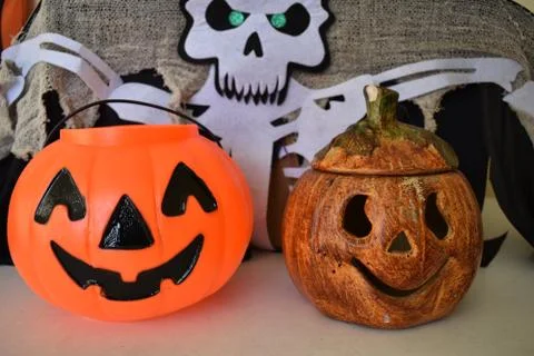 A plastic pumpkin next to a ceramic one for halloween decoration Stock Photos