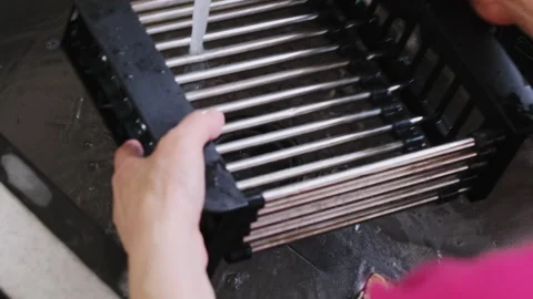 Plastic rack gets final rinse in swirl of clean water jets Stock Footage 316171379