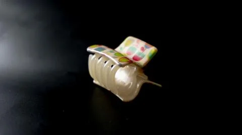 Plastic Rectangular white clutcher of big teeth with art of different flower Stock Photos