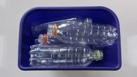 Plastic Recycle bottles get thrown into blue bin Vídeos de archivo 80640824