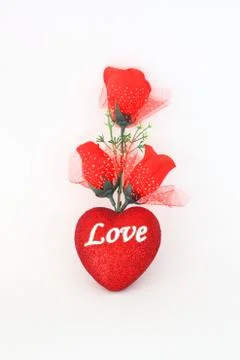 Plastic red roses on a white background. Fotos Stock