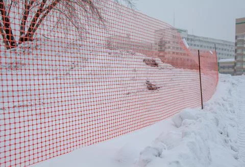 Plastic red safety net for construction site. Fencing repair work Stock Photos
