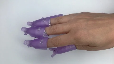 Plastic reusable cap clip for soak-off UV gel polish removal. Stock Footage 117676279