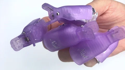 Plastic reusable cap clip for soak-off UV gel polish removal. Stock Footage 117677221