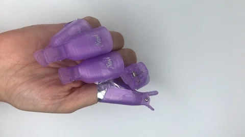 Plastic reusable cap clip for soak-off UV gel polish removal. Stock Footage 117822035