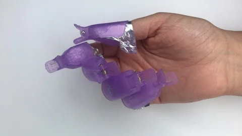 Plastic reusable cap clip for soak-off UV gel polish removal. Stock Footage 117822068