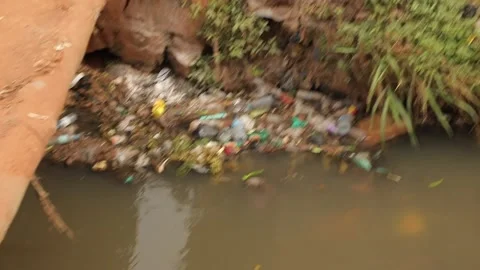 Plastic rubbish trash in the dump river in African slum street, Uganda Kampala. Stock Footage 211417541