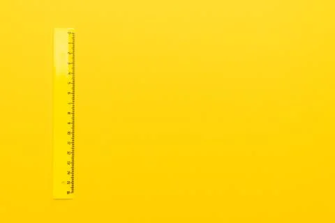 Plastic ruler on yellow Stock Photos