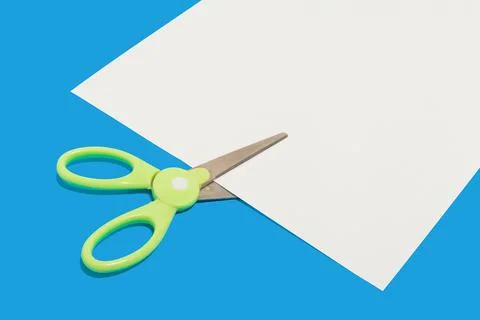 Plastic scissors cutting a paper. school accessories Stock Photos