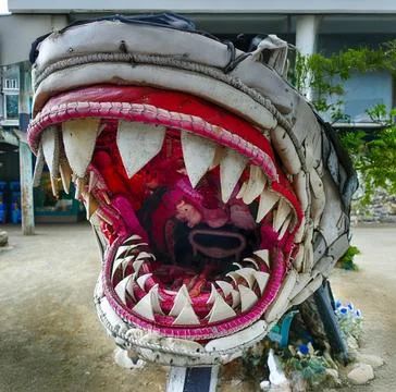 Plastic shark sculpture revealing sharp teeth, crafted from ocean waste and.. Stock Photos