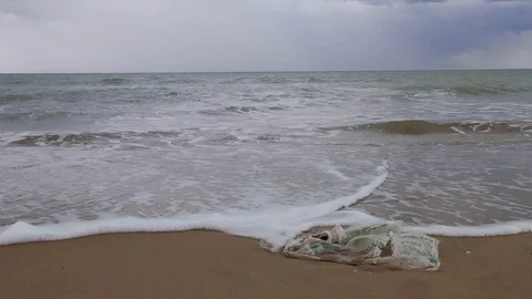 Plastic on the shore of the beach polluting our oceans and seas. Stock Footage 119926107