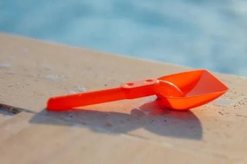 Plastic shovel on pool edge Stock Photos