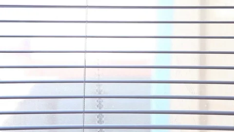 Plastic shutters are slowly closing. Part of a close-up window Stock Footage 73450635