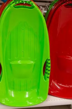 Plastic sleds for skiing from the mountain Stock Photos