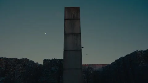 Plastic Sorting Facility Building Exterior with Stacked Trash Bales Dusk Stock Footage 331166558