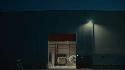 Plastic Sorting Facility Building Exterior with Yellow Loader at Night Stock-Footage 331166625