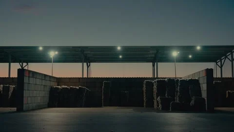 Plastic Sorting Facility with Compressed Waste Bales Under Outdoor Lights Stock Footage 331166612
