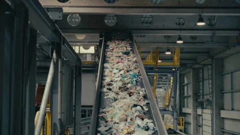 Plastic Sorting Facility Featuring a Massive Conveyor Belt Carrying Waste Stock Footage 331166497