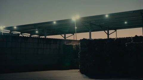 Plastic Sorting Facility Storage Area at Dusk with Industrial Lights on 库存影片 331166606