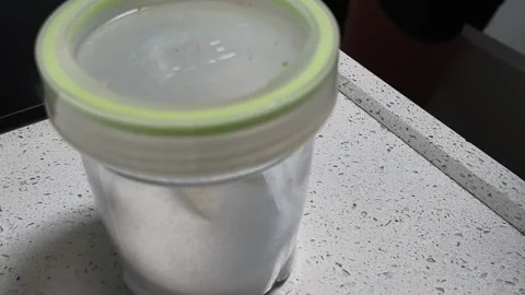 Plastic Spice Jar With Yellow Lid On Kitchen Countertop Vídeos de archivo 343293378