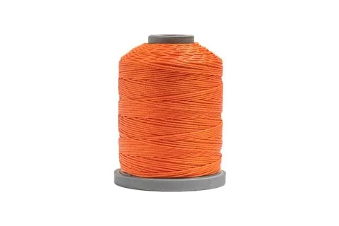 Plastic spool with bright orange threads isolated on white background. Foto stock