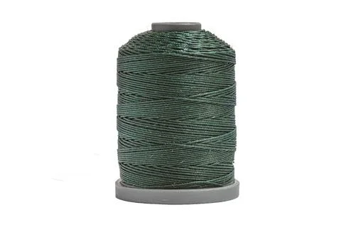 Plastic spool with dark green threads isolated on white background. Stock-Fotos